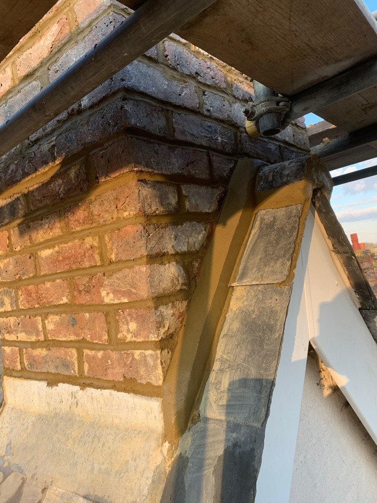 Restored brick corbel and repointed stonework detail