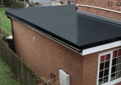 New black flat roof installed on a brick extension