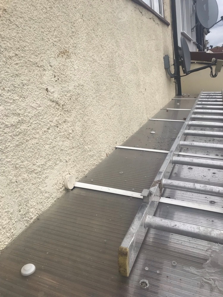 Ladder access across a new flat roof for repairs
