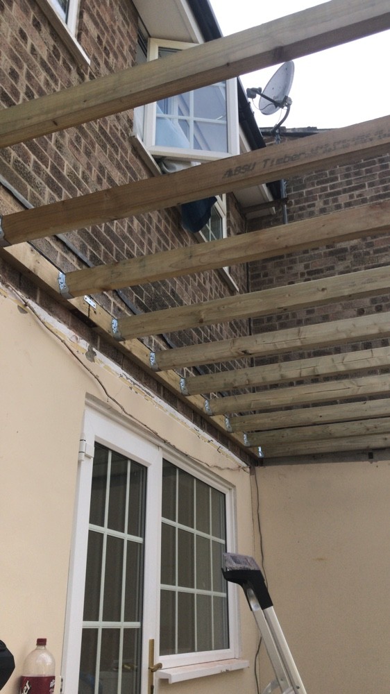 Brandals roofer accessing a tiled roof by ladder for repairs