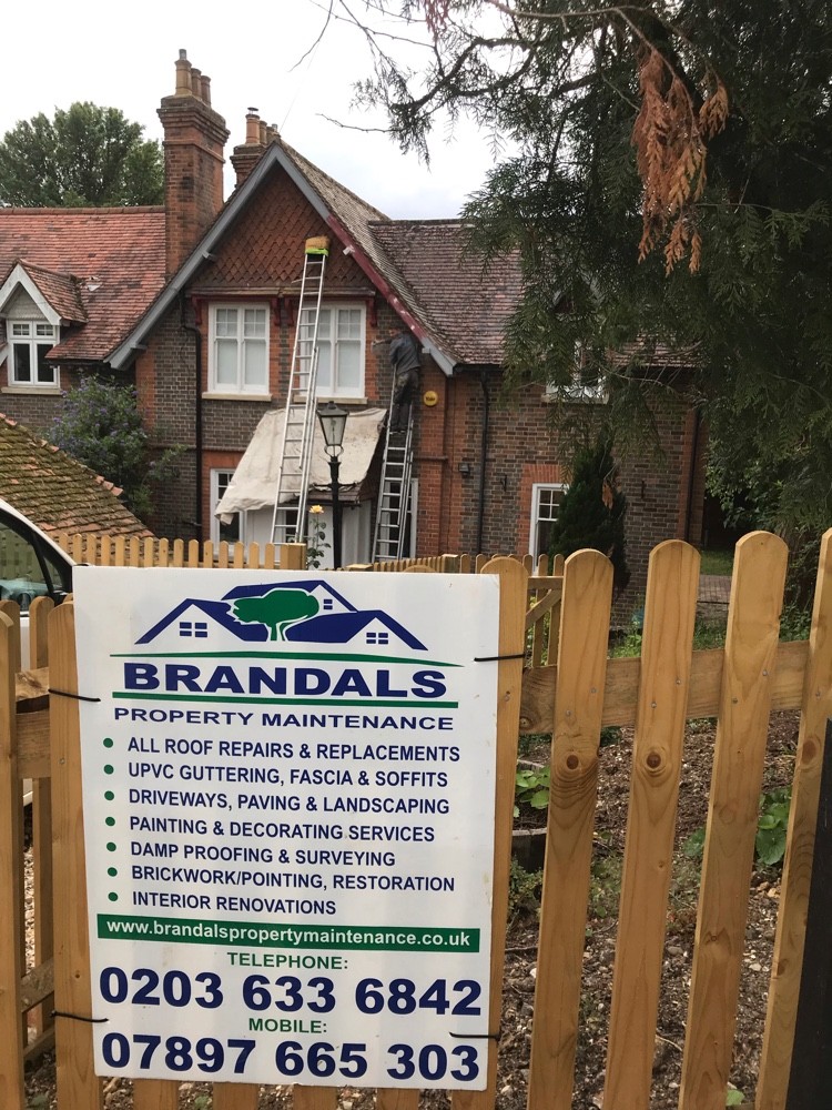 Roof repairs on a period cottage with Brandals site board