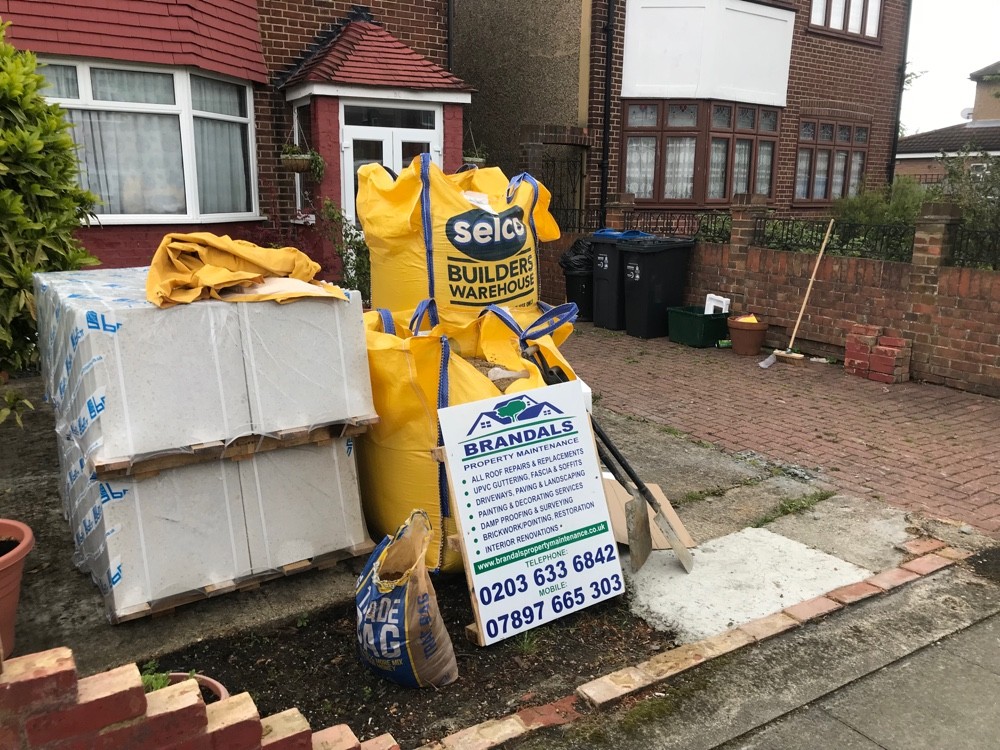 Materials and skip bags on site outside a London home